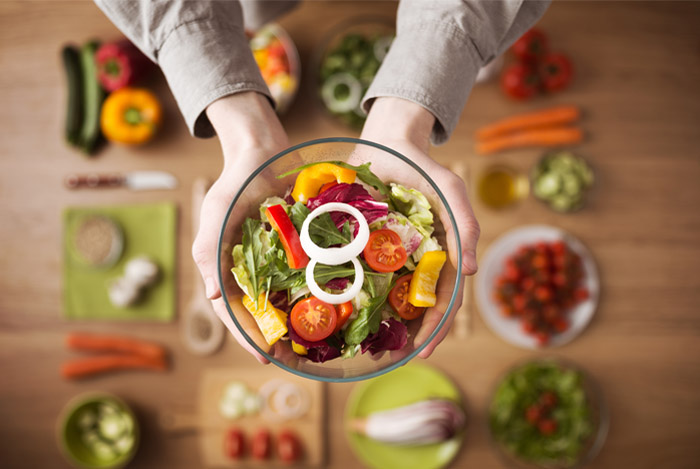 hands bowl fresh vegan food